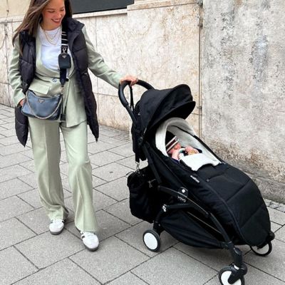 maman main dans poches près chancelière poussette